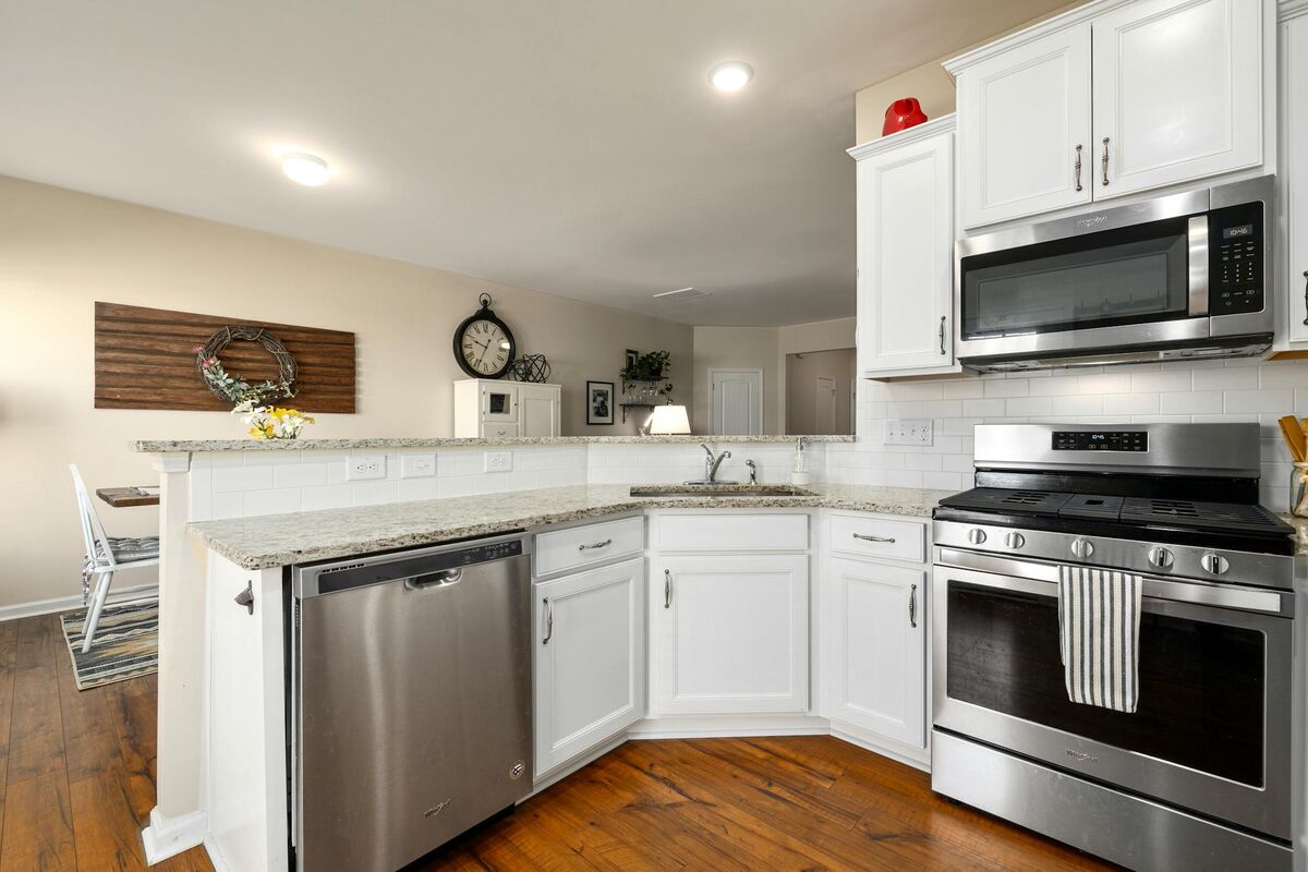 Kitchen renovation with white cabinets and marble countertops in Kelowna